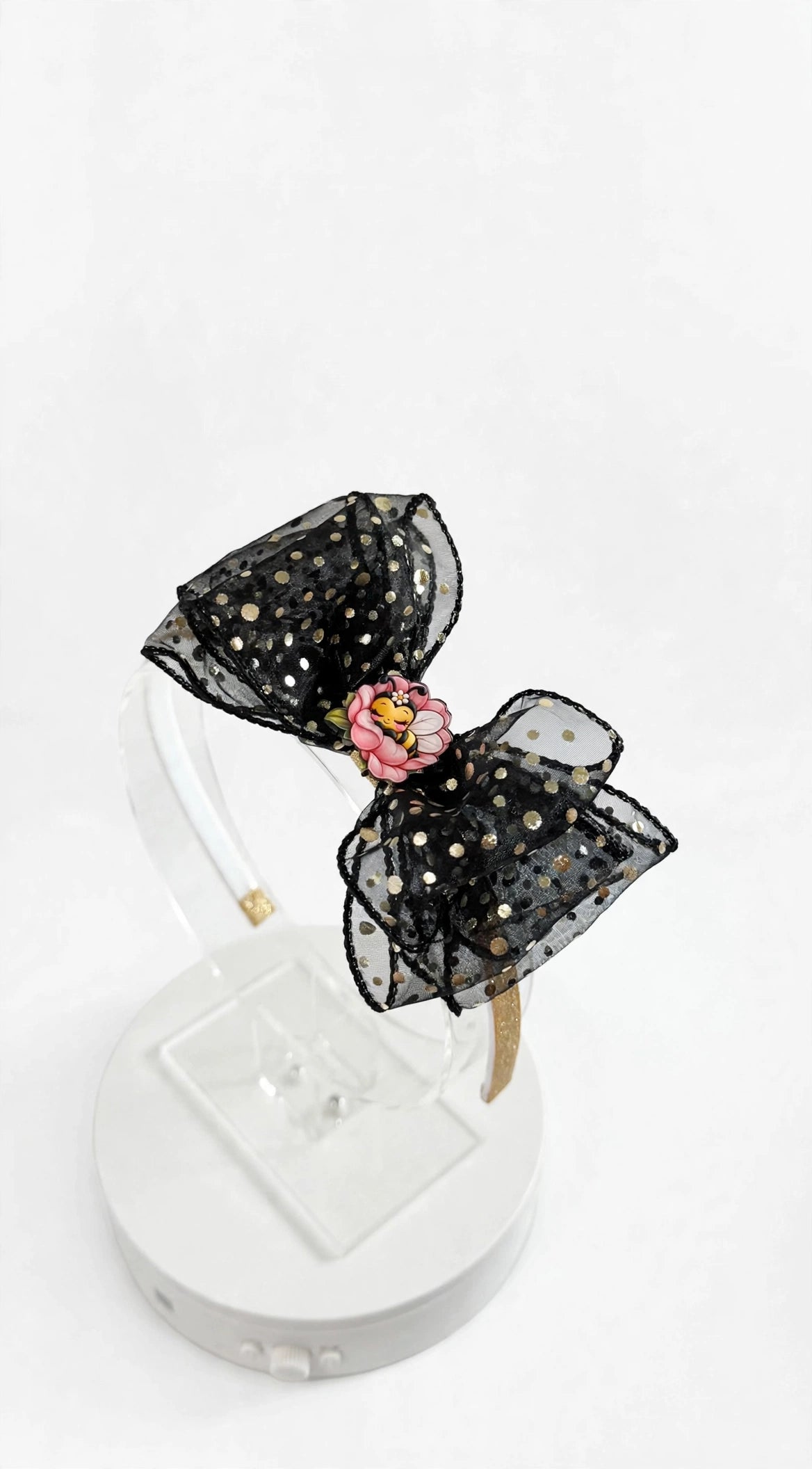 Black sheer headband with gold polka dots and pink flower with sleeping bee