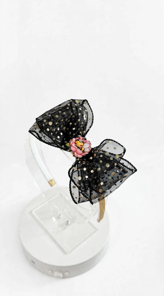 Black sheer headband with gold polka dots and pink flower with sleeping bee